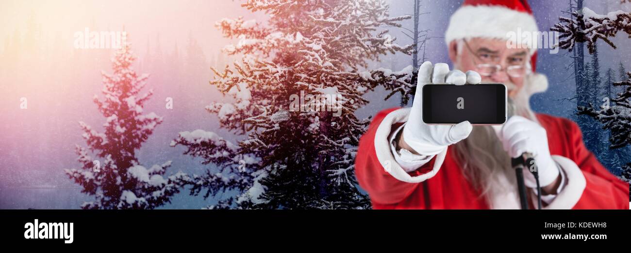 Digital composite of Santa Claus in Winter with phone Stock Photo - Alamy