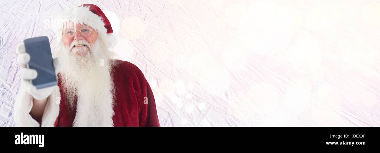 Digital composite of Santa holding phone Stock Photo - Alamy
