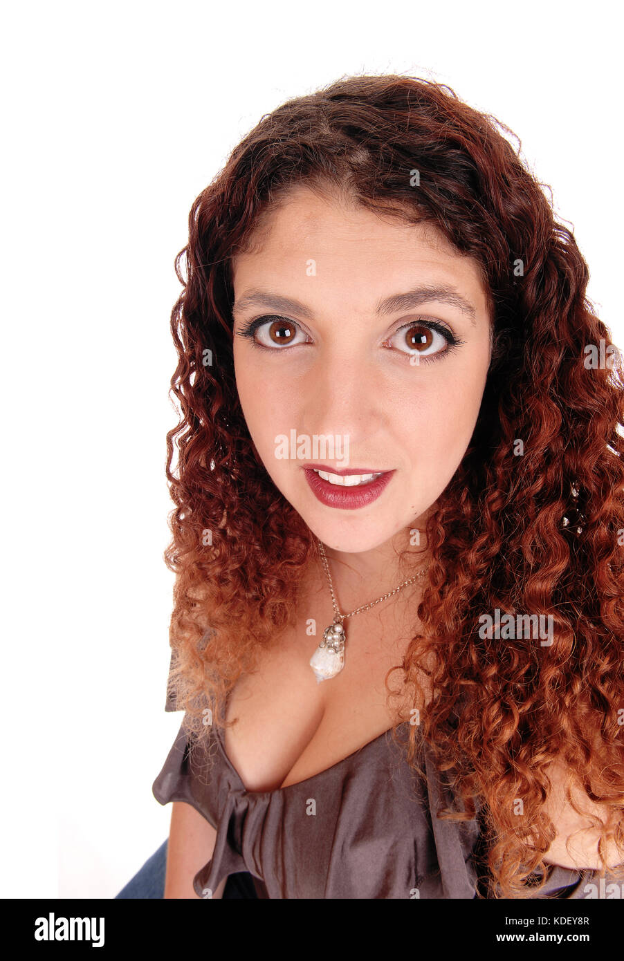A closeup portrait of a beautiful woman with curly brunette hair ...
