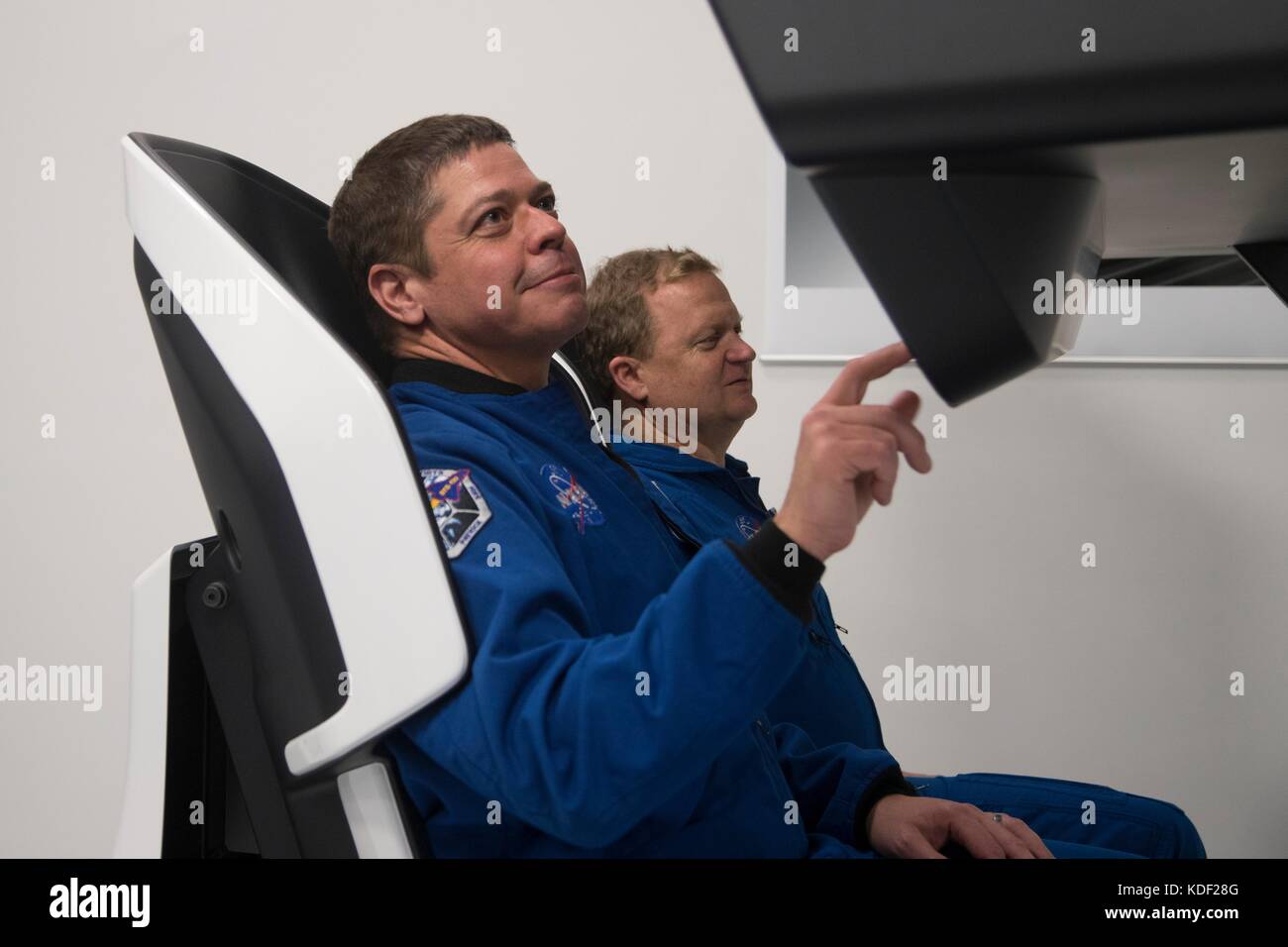 NASA astronauts Bob Behnken (left) and Eric Boe evaluate a mock-up of the SpaceX Crew Dragon spacecraft flight deck at the SpaceX Headquarters March 8, 2017 in Hawthorne, California.   (photo by NASA Photo via Planetpix) Stock Photo