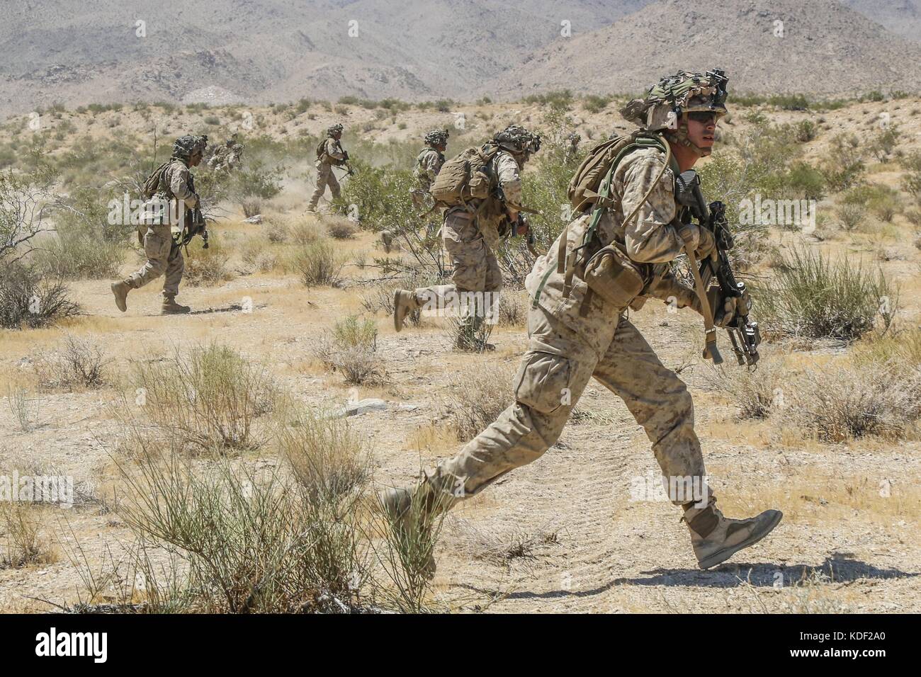 U.S. soldiers run during an assault drill at the Fort Irwin National Training Center Alpine Pass June 30, 2017 in Fort Irwin, California.   (photo by Austin Anyzeski  via Planetpix) Stock Photo