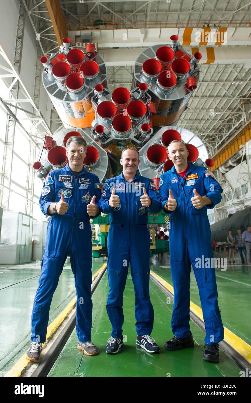 NASA International Space Station Expedition 52 prime crew members (L-R) Italian astronaut Paolo Nespoli of the European Space Agency, Russian cosmonaut Sergey Ryazanskiy of Roscosmos and American astronaut Randy Bresnik give a thumbs-up while posing in front of the Soyuz MS-05 spacecraft booster rocket engines at the Baikonur Cosmodrome Integration Facility during their final pre-launch fit check dress rehearsal July 24, 2017 in Baikonur, Kazakhstan.   (photo by Andrey Shelepin  via Planetpix) Stock Photo