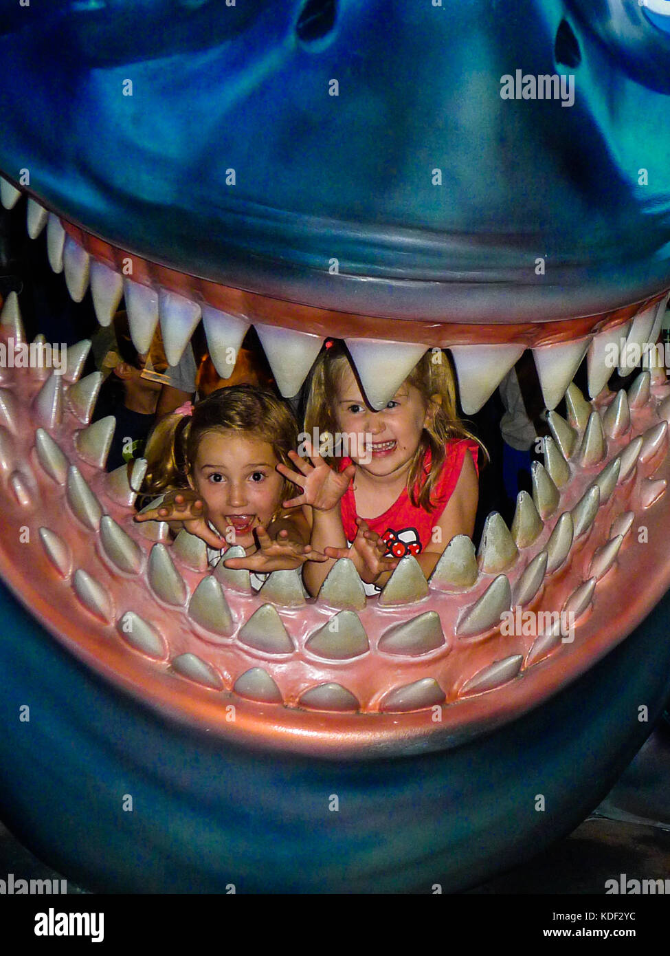 Children, Kids in Jaws Mouth, Shark, Whale, Attraction Disneyworld, Orlando Florida USA Stock Photo
