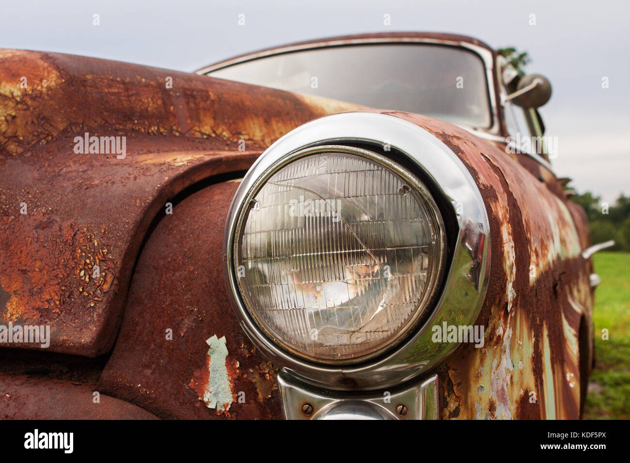 Cracked headlight on old rusted junkyard car Stock Photo Alamy