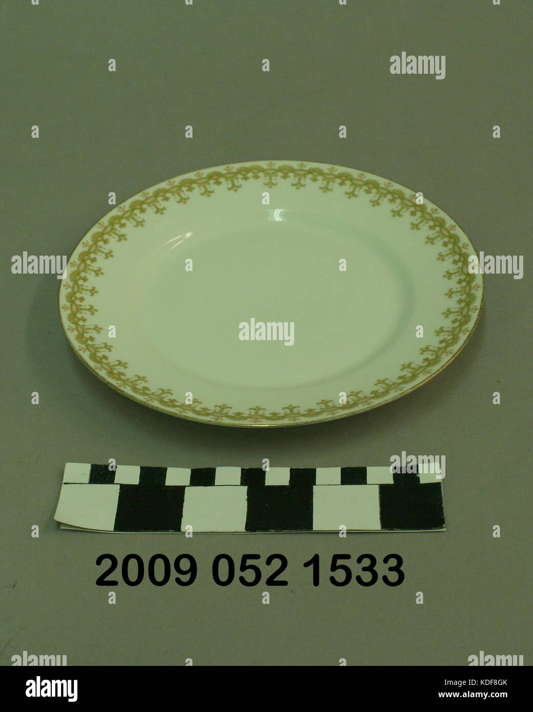 Small White Ceramic Plate With Floral Decorated Border Stock Photo