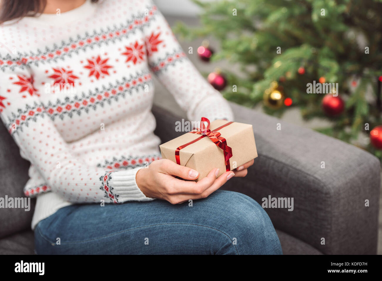 girl holding christmas gift Stock Photo - Alamy