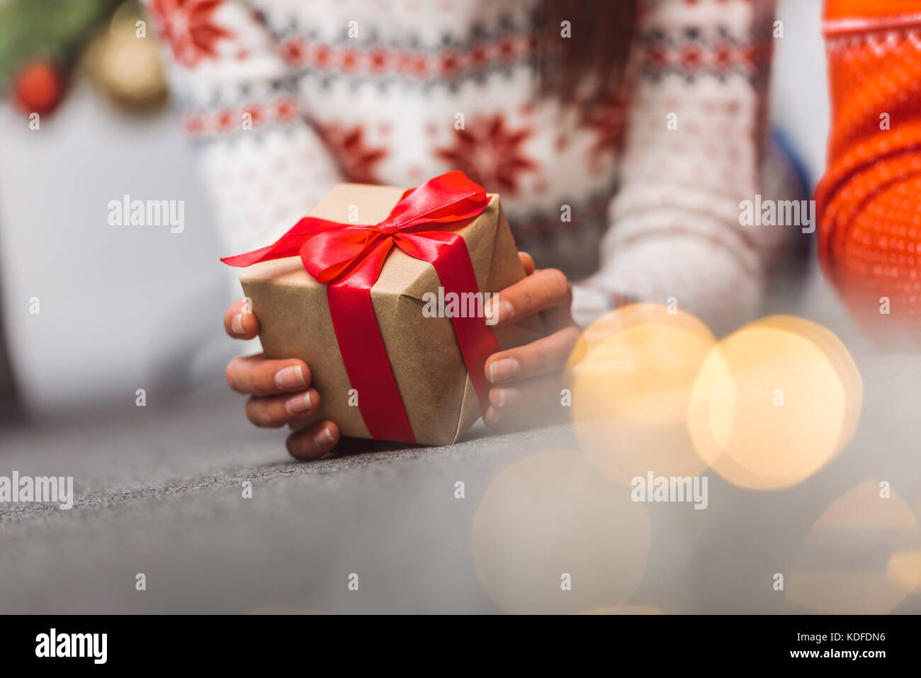 girl holding christmas present Stock Photo - Alamy