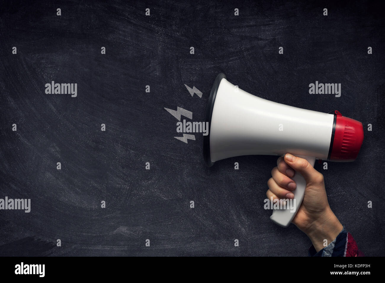 hand with megaphone on chalkboard with copy space Stock Photo