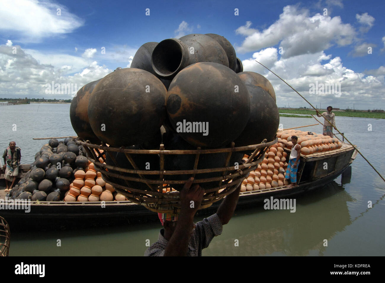 Khulna, Bangladesh A Bangladeshi worker carries clay pot to deliver in