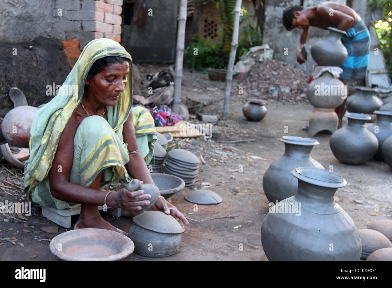 Khulna, Bangladesh Potter makes clay pot using a traditional wheel at