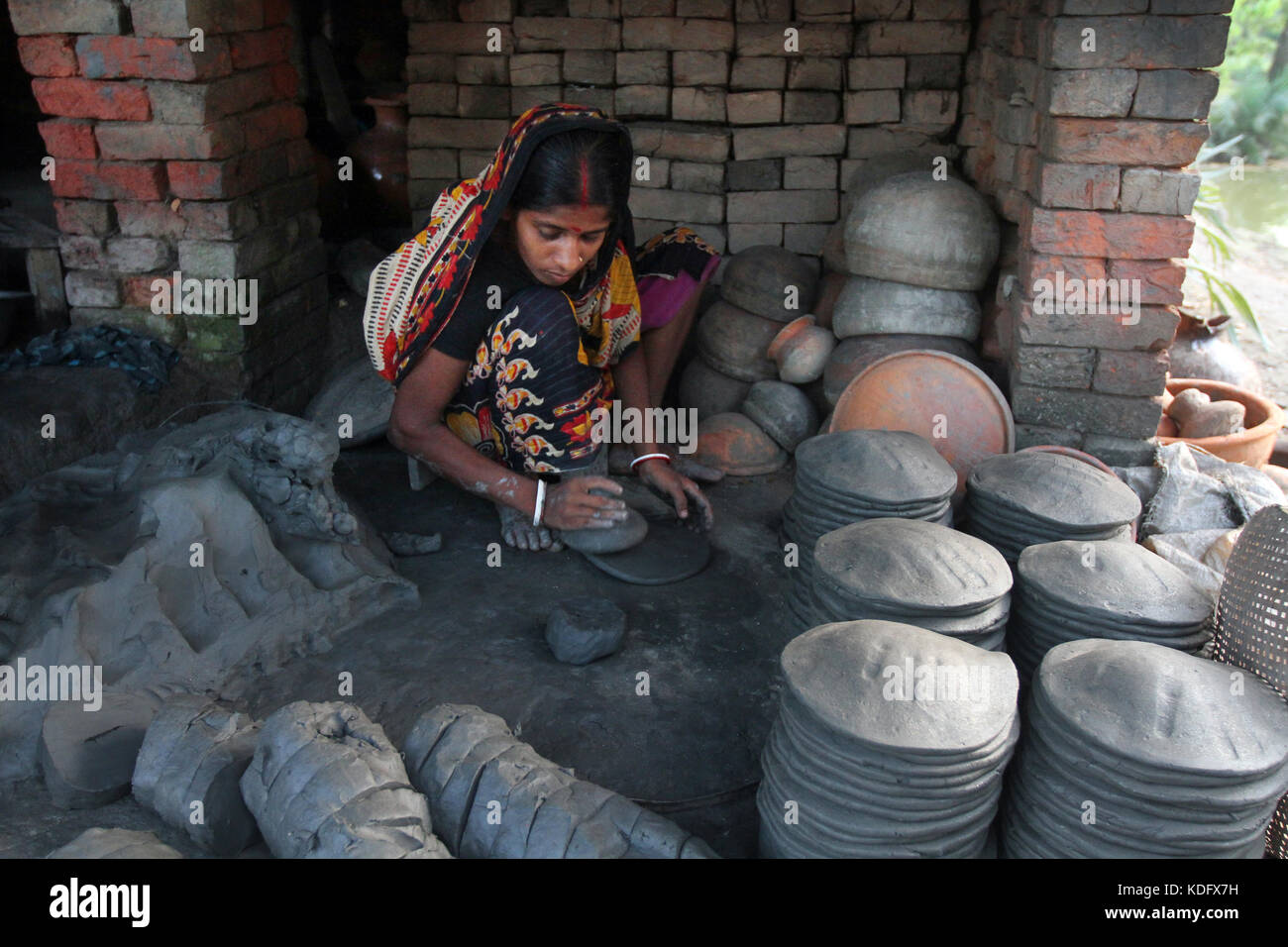 Khulna, Bangladesh Potter makes clay pot using a traditional wheel at