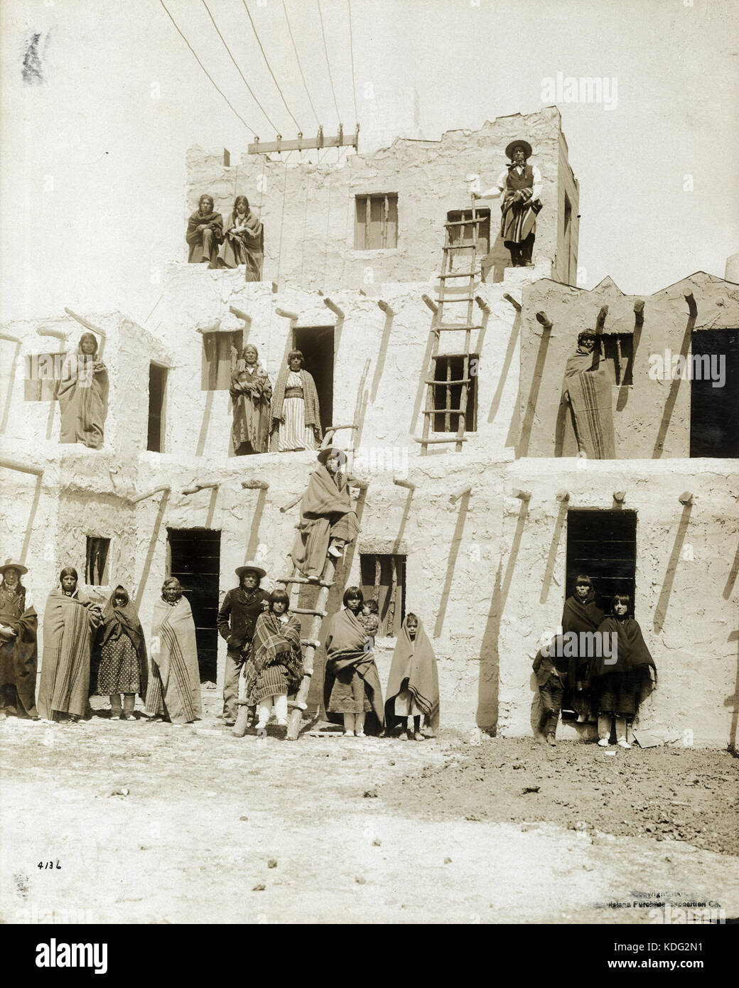Pueblo Indians in front of a three storey Pueblo housing reproduction in the Department of Anthropology at the 1904 World's Fair Stock Photo