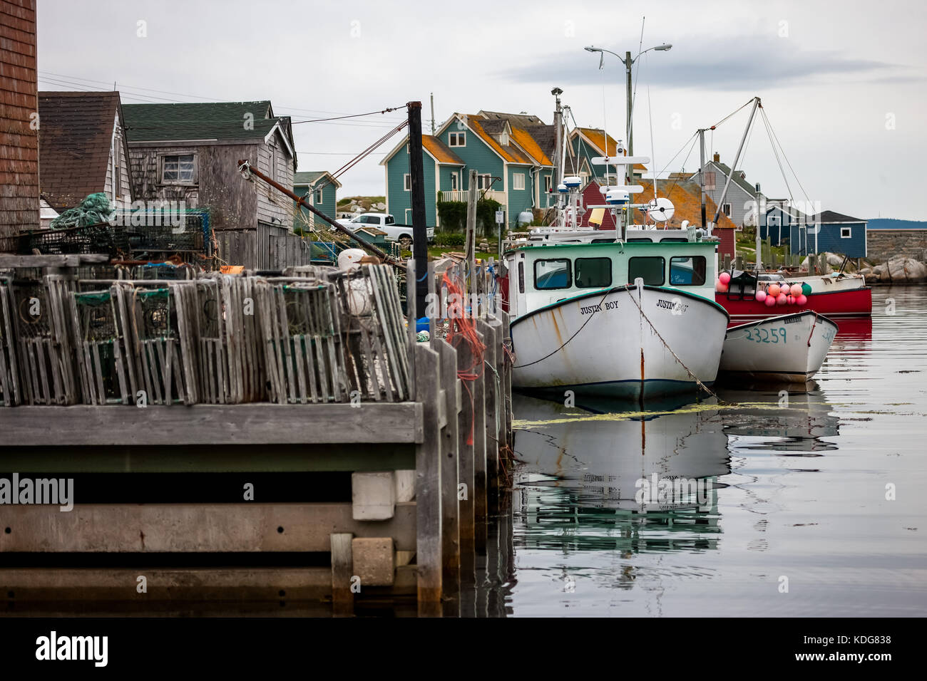 Commercial fishing boats along with their traps, lines and markers tied up to the docks in Peggy's Cove, Nova Scotia on August 30, 2017. Stock Photo