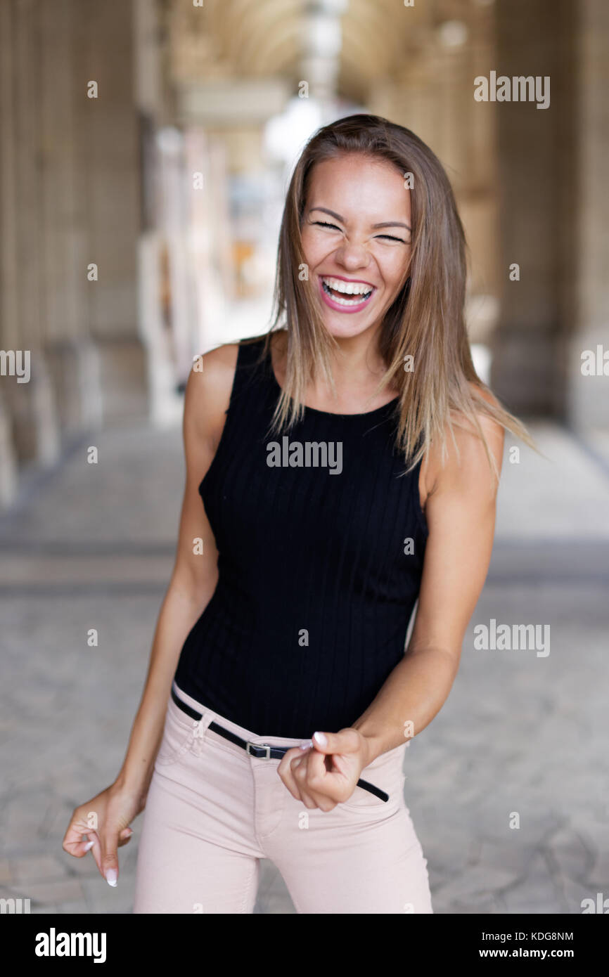 Young brunette woman laughing on jokes outdoor Stock Photo