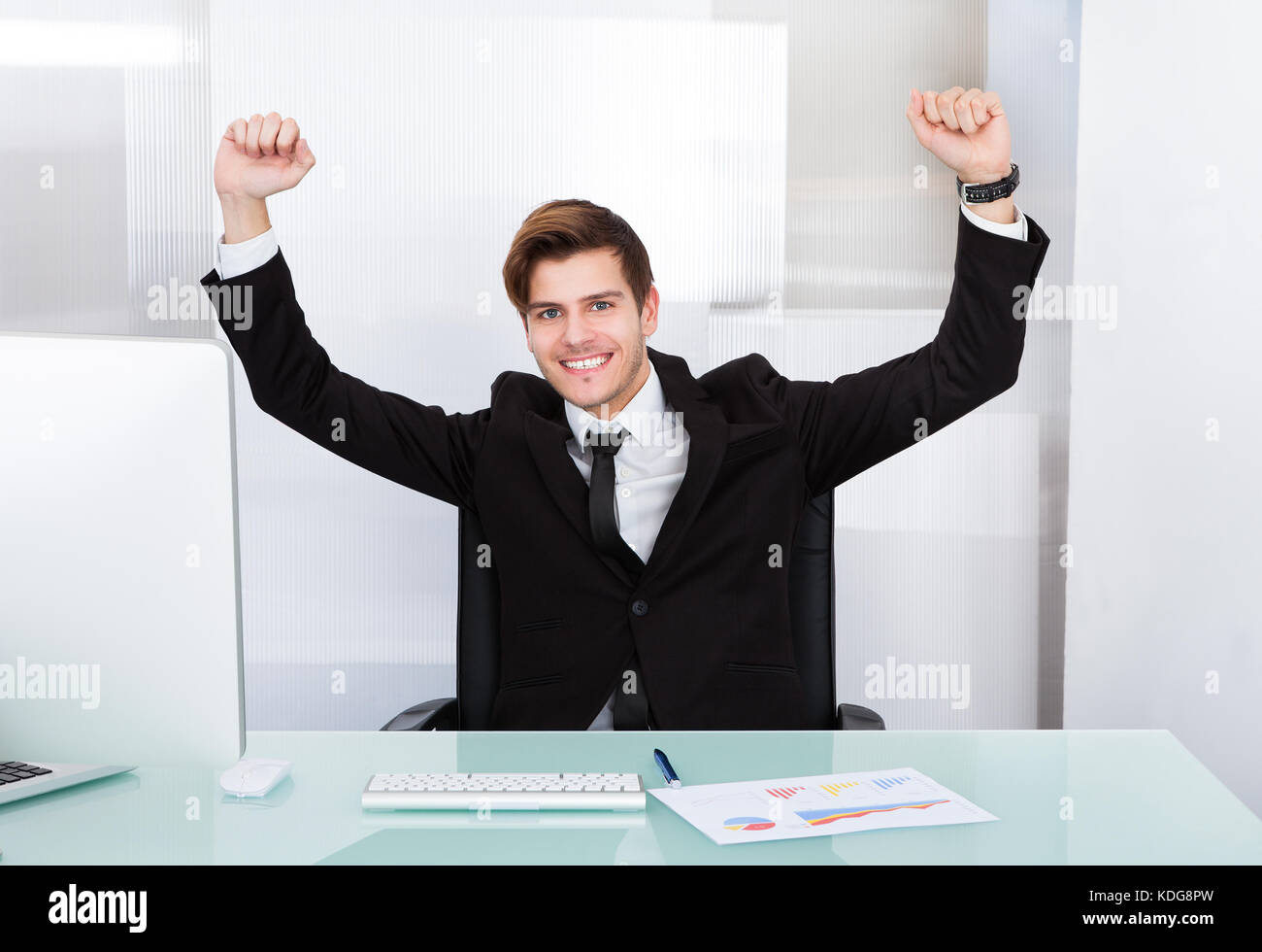 Happy Young Successful Excited Businessman Raising Hand Stock Photo