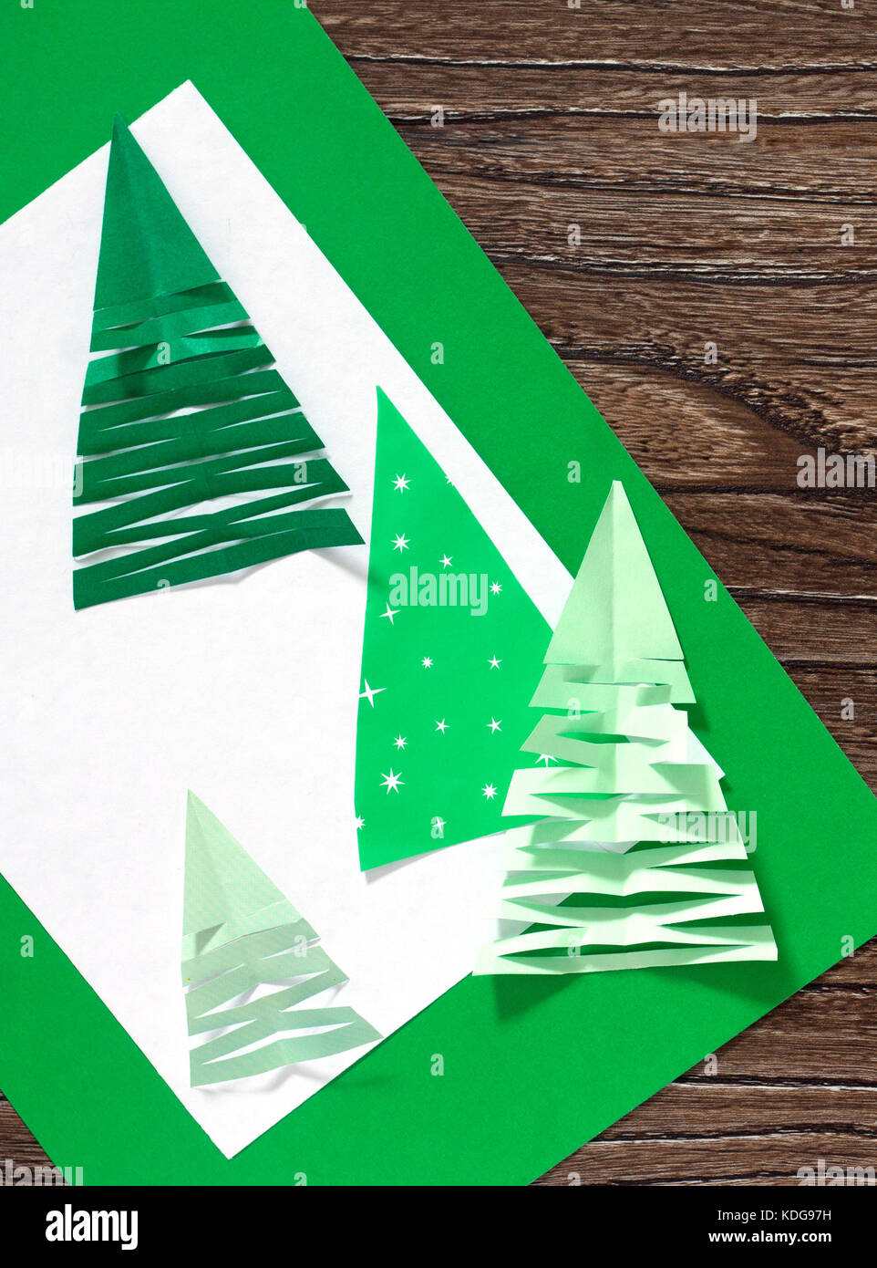 Christmas frame. The child makes paper fir tree. Children's art project