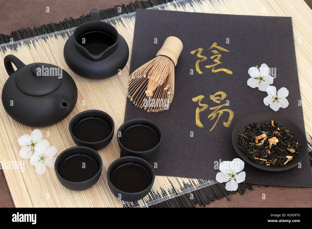 Chinese jasmine tea with yin and yang chinese calligraphy script, cherry blossom, teapot, cups