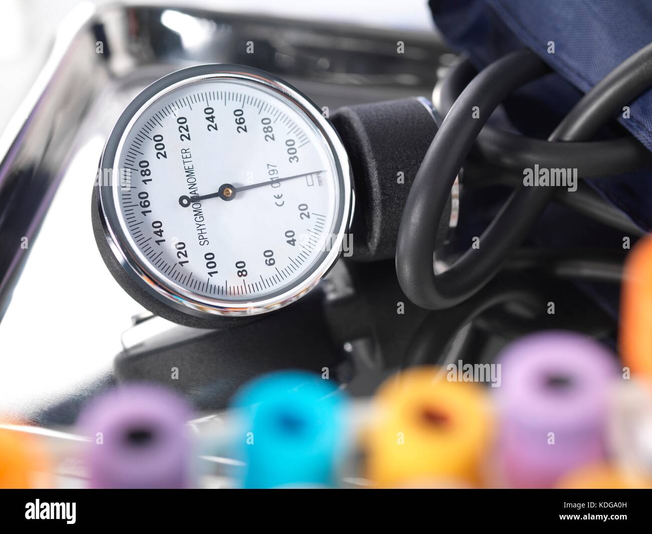 Blood pressure gauge on a surgical tray with medical samples in the foreground. Stock Photo