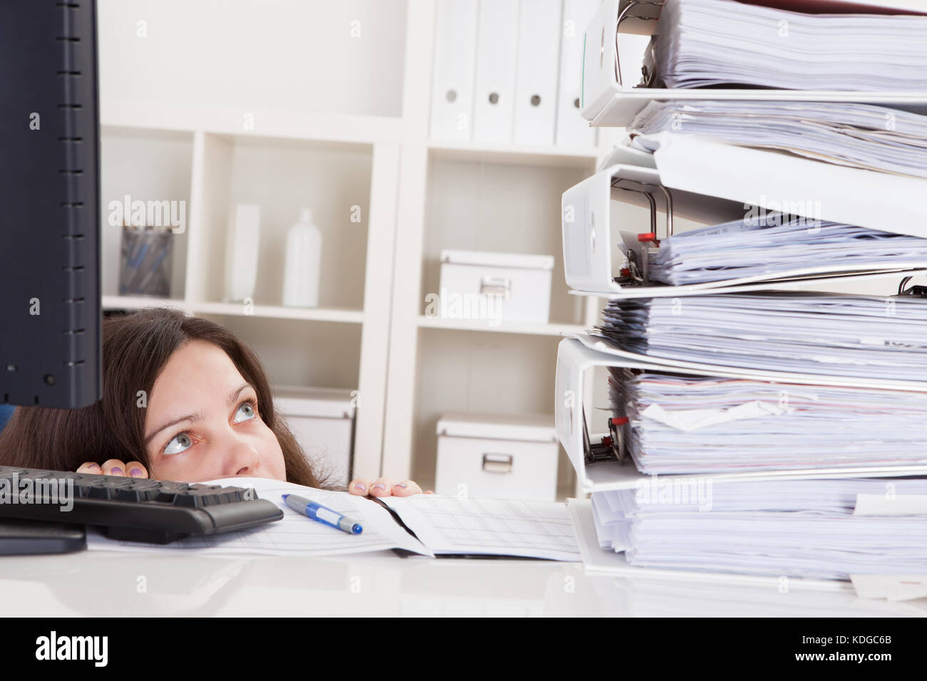Businesswoman In Office Looking At Stack Of Folders Stock Photo - Alamy