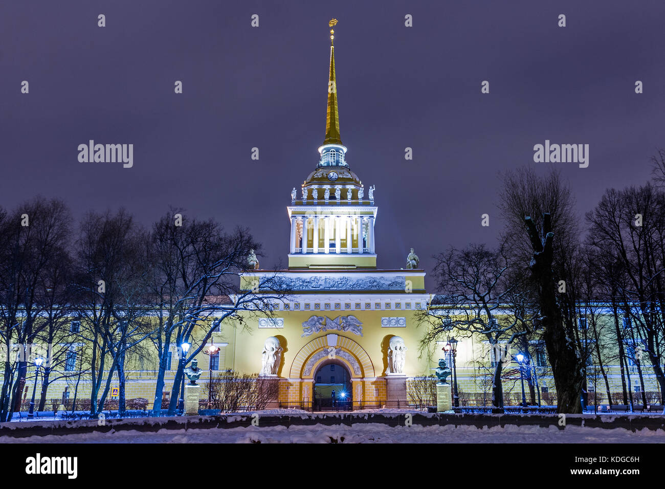 Old historical architecture landmark and touristic spot in Saint Petersburg, Russia: historical Admiralty building by a winter night with park and tre Stock Photo