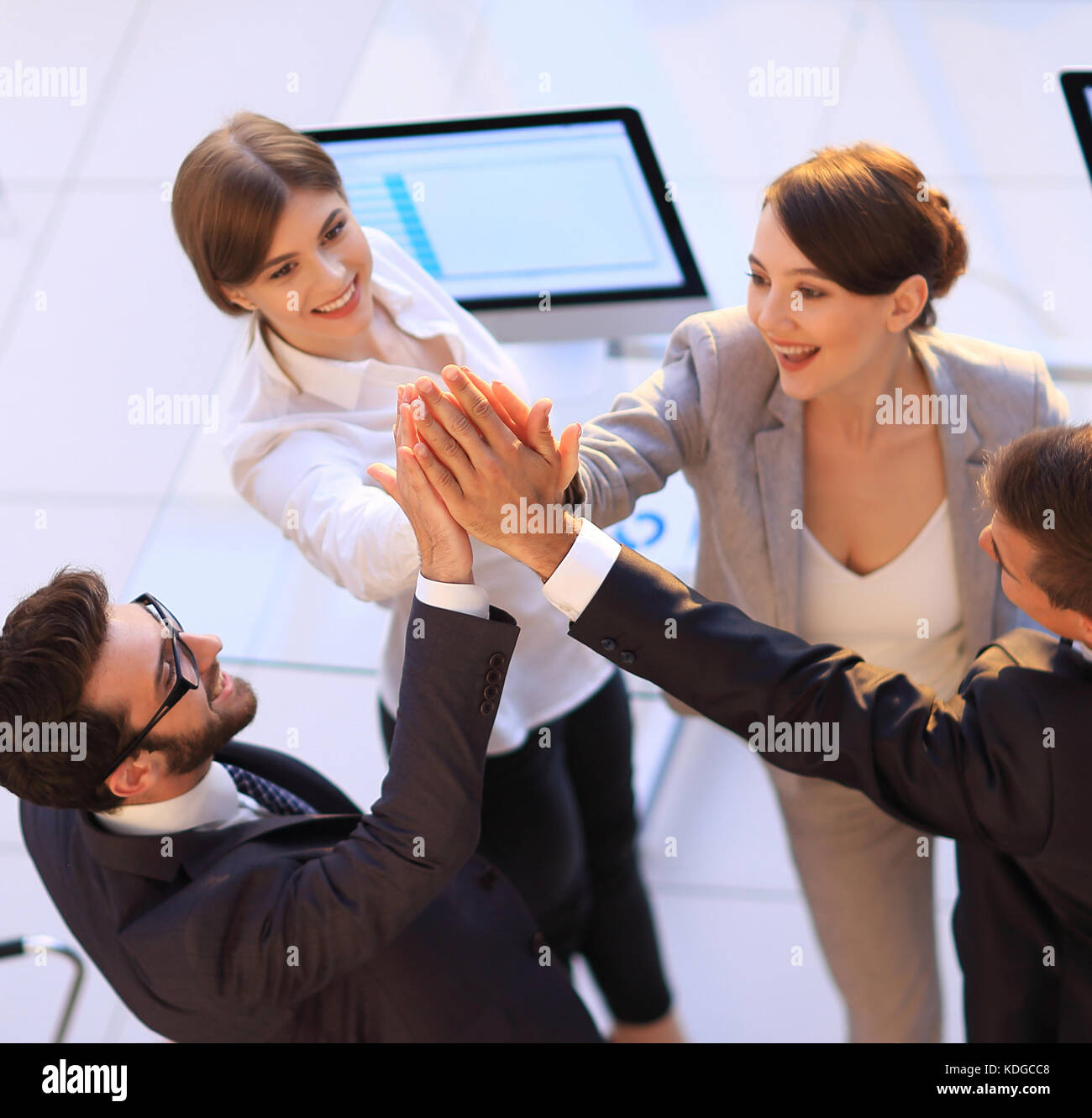 successful business team giving each other a high-five, standing in the ...