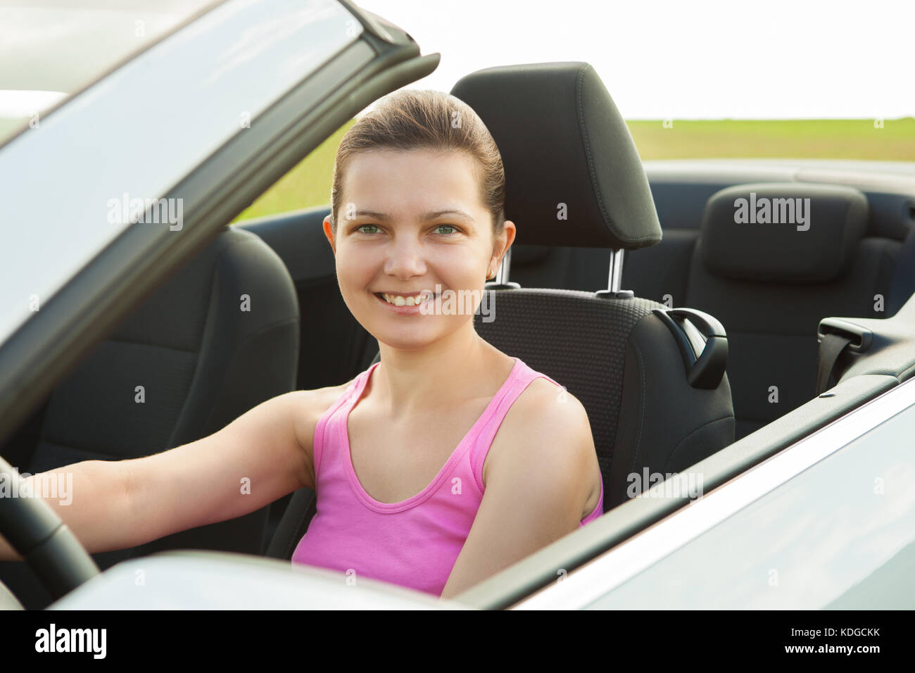 Portrait Of Happy Young Woman Sitting In Car Stock Photo - Alamy