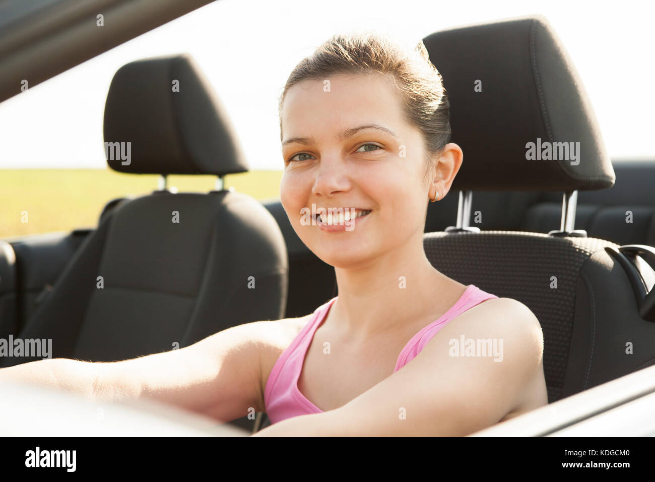 Happy Young Woman Sitting In Her Car Stock Photo - Alamy
