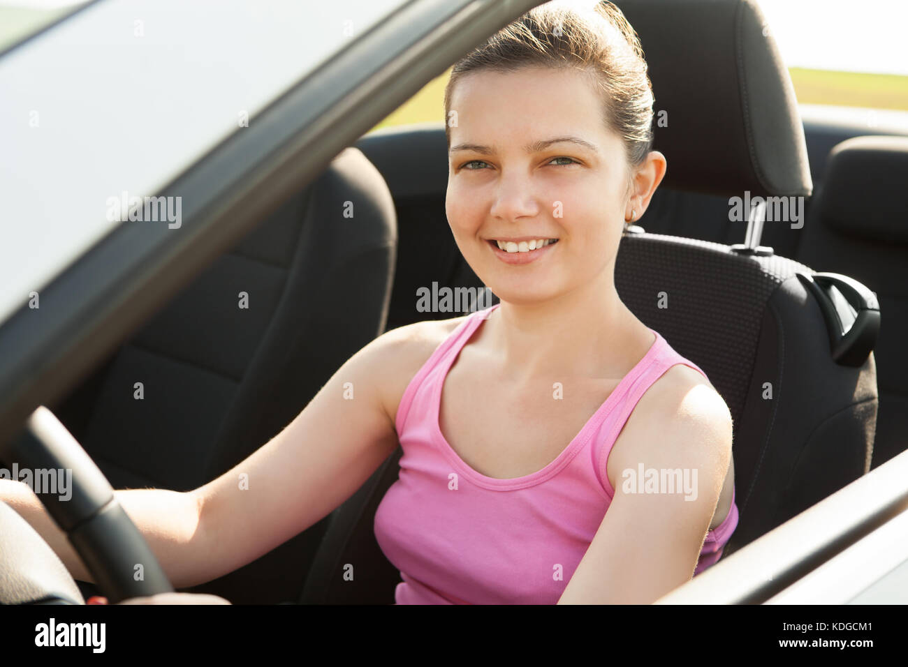 Happy Young Woman Sitting In Her Car Stock Photo - Alamy