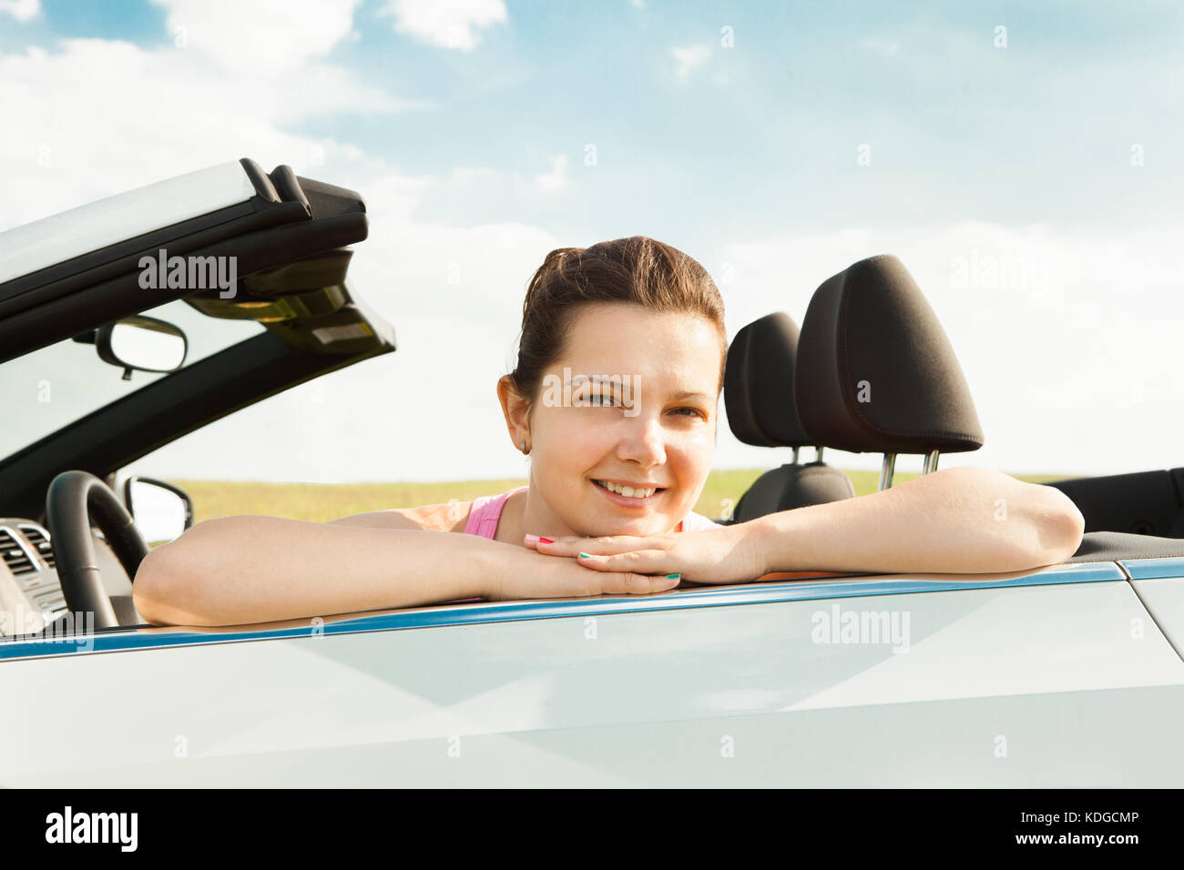 Happy Young Woman Sitting In Her Car Stock Photo - Alamy