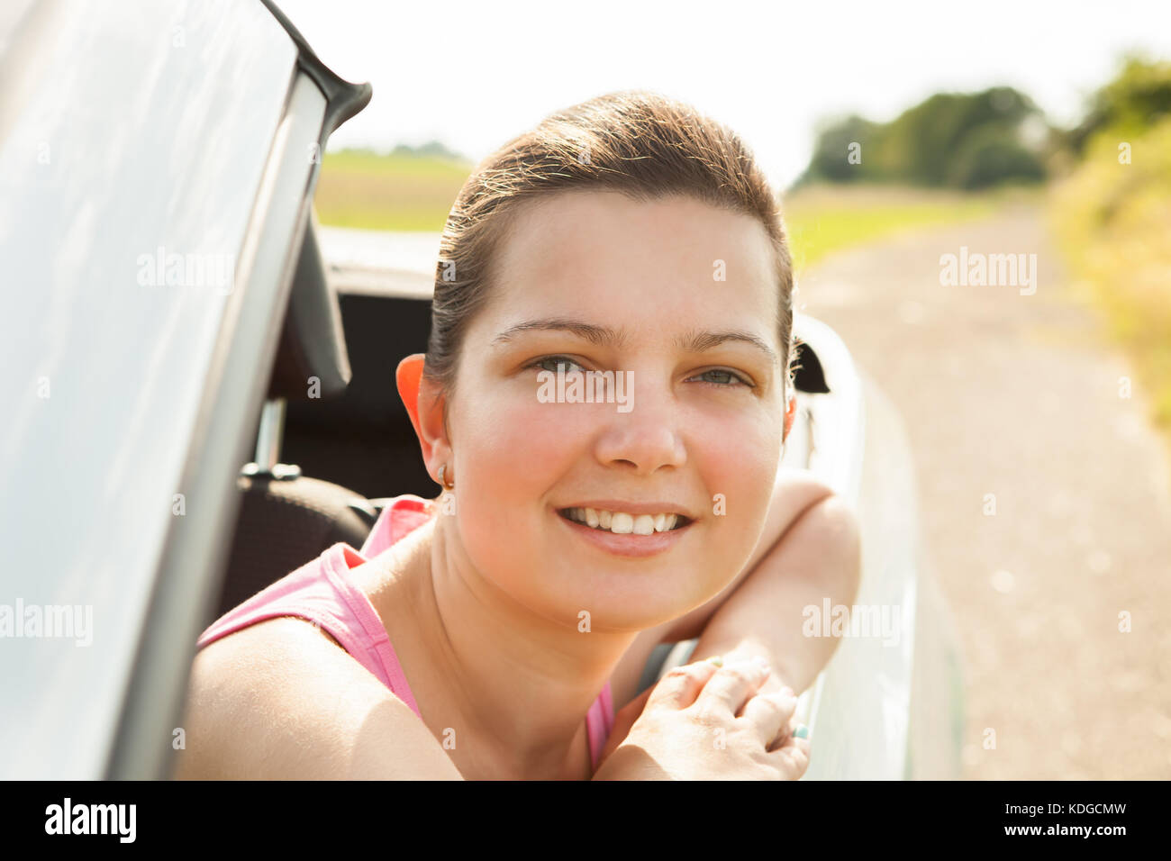 Happy Young Woman Sitting In Her Car Stock Photo - Alamy