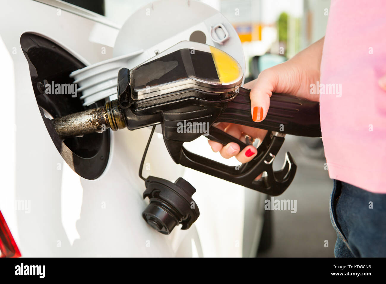 Male Hand Refilling The Car With Fuel On A Filling Station Stock Photo