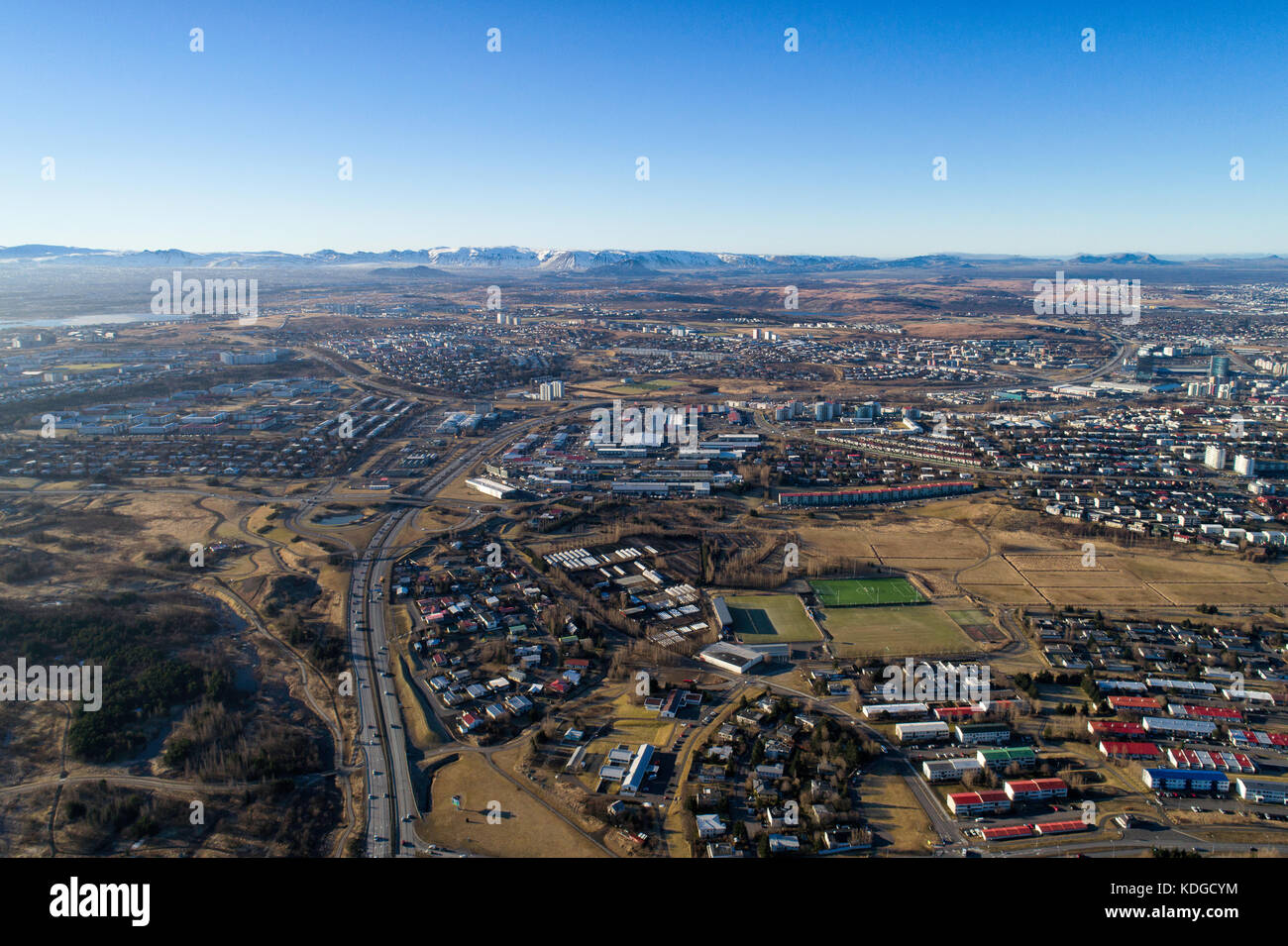 Aerial photograph overlooking Kopavogur town, a suburb of Reykjavik, the capital of Iceland. Mountains in background shot on a sunny day Stock Photo