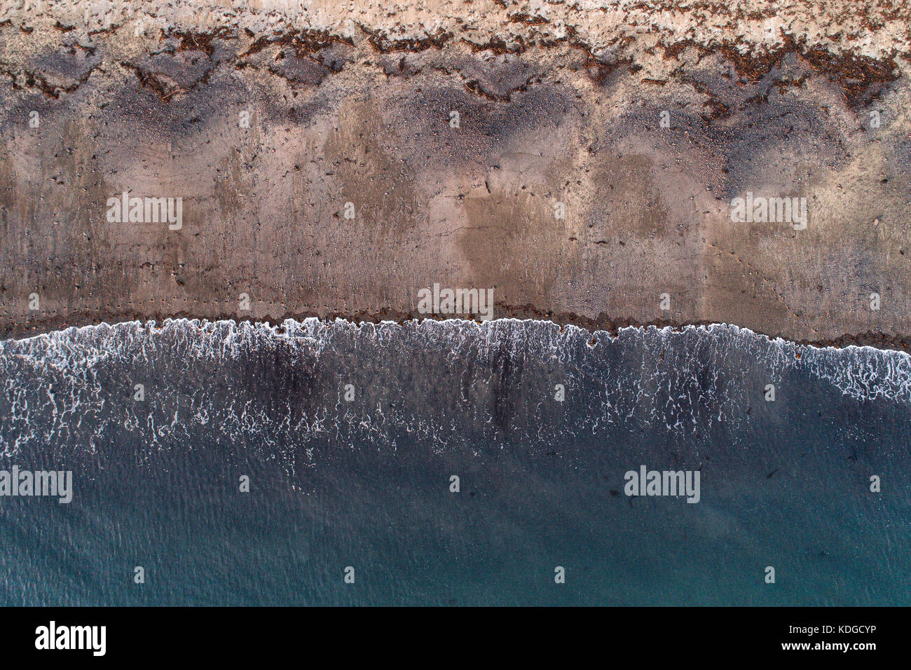 Aerial view of a sandy beach, waves breaking on the white sand Stock Photo