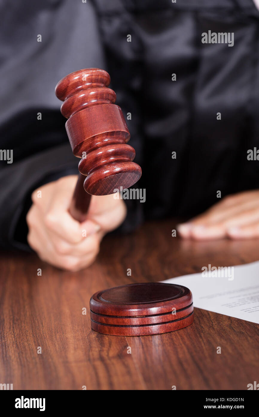 Close-up Of Judge Striking The Gavel In A Courtroom Stock Photo