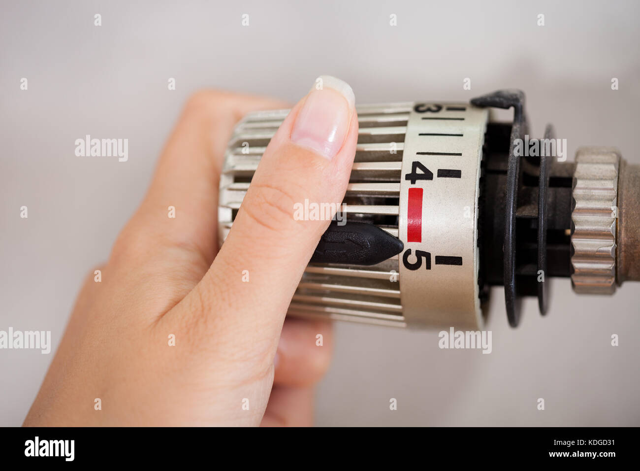 Woman Hand Adjusting The Temperature By Thermostat Stock Photo - Alamy