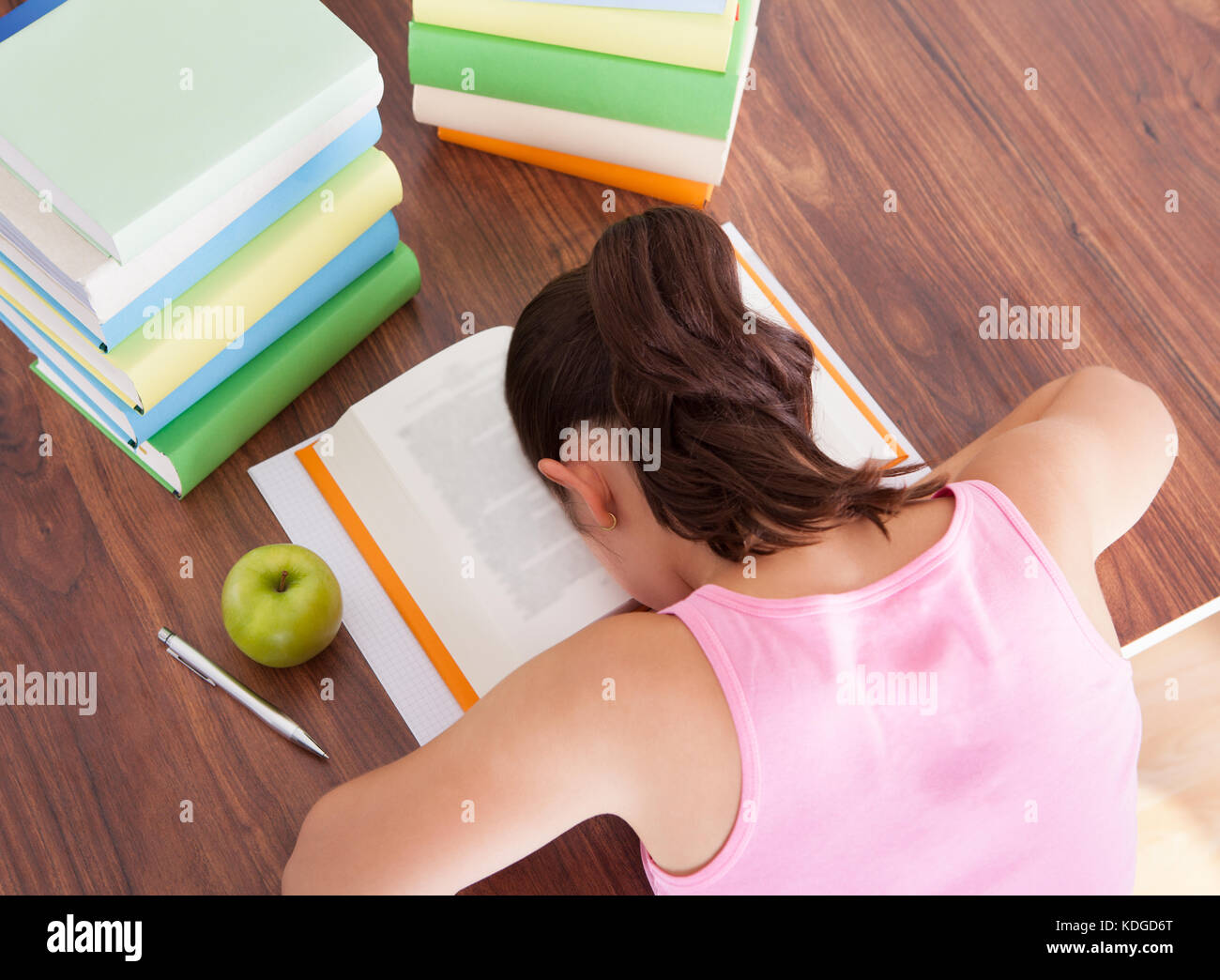 High angle view of a Tired student sleeping on book Stock Photo