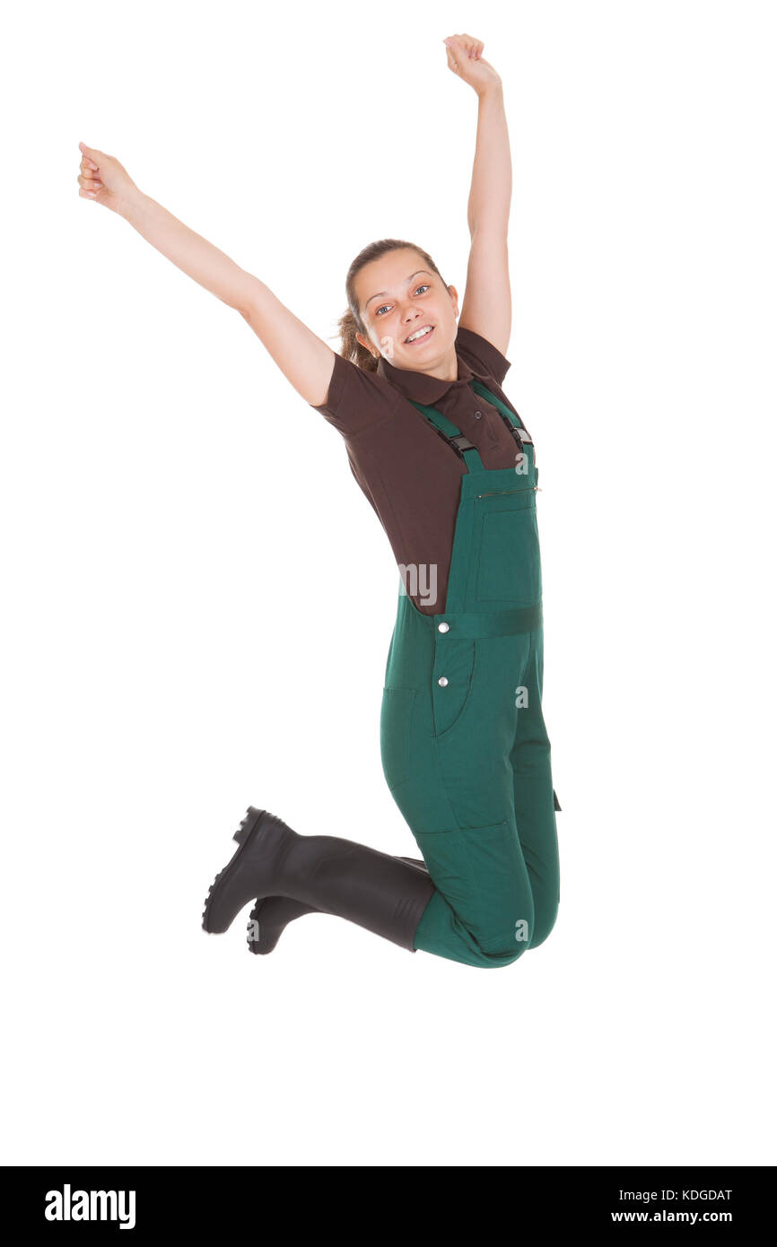 Portrait Of Excited Young Woman Jumping over white background Stock Photo