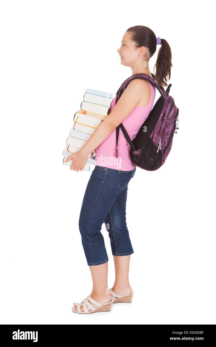 Young female student holding stack of books on white background Stock ...