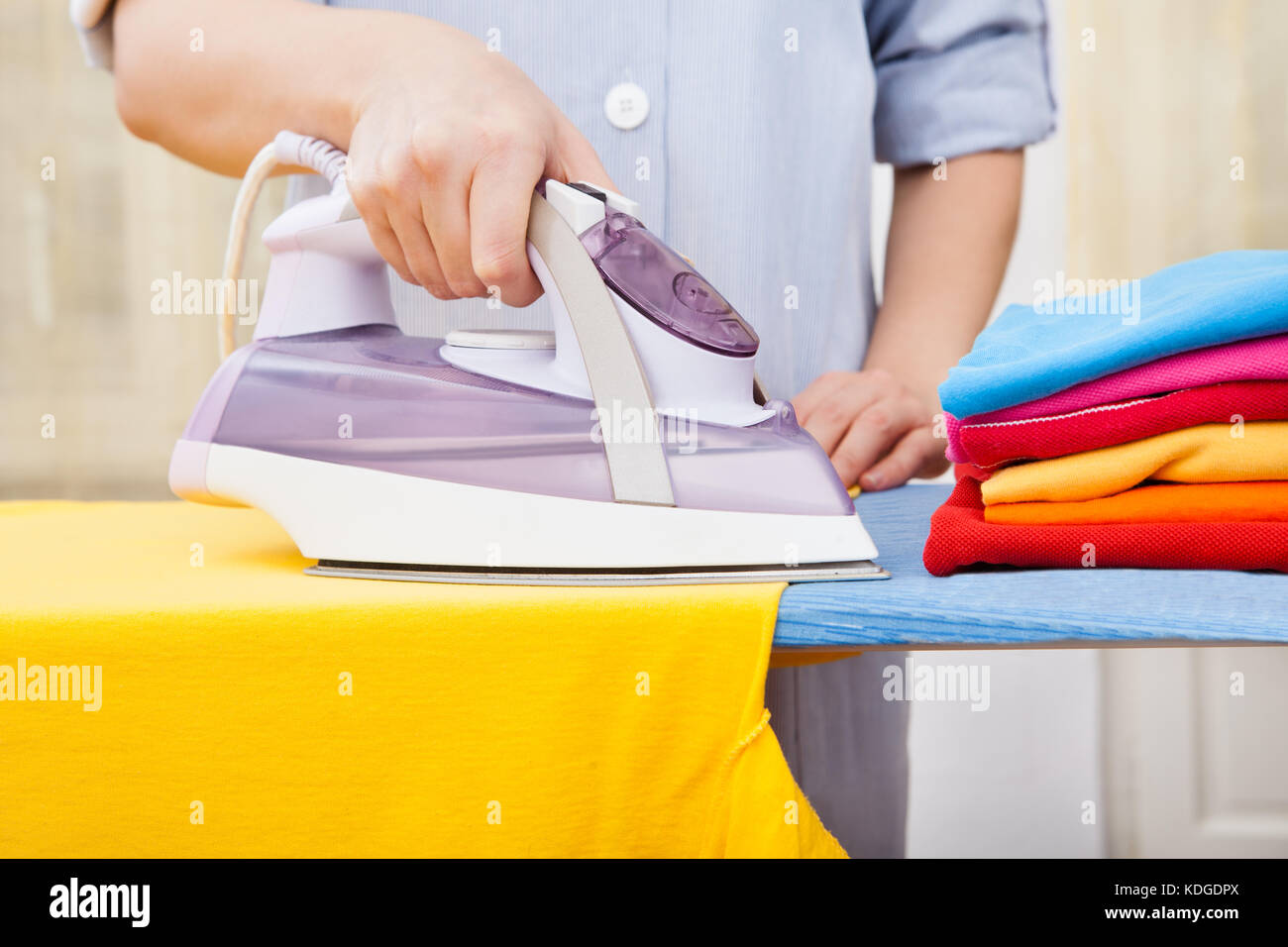 Close-up Of Woman's Hand Ironing Cloth On Ironing Board Stock Photo - Alamy