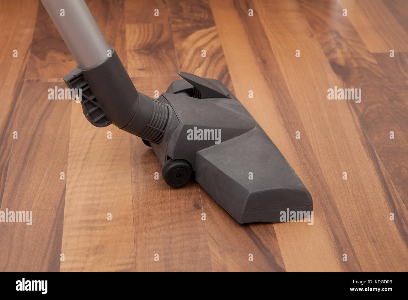 Close-up Of Vacuum Cleaner Cleaning Hardwood Floor Stock Photo