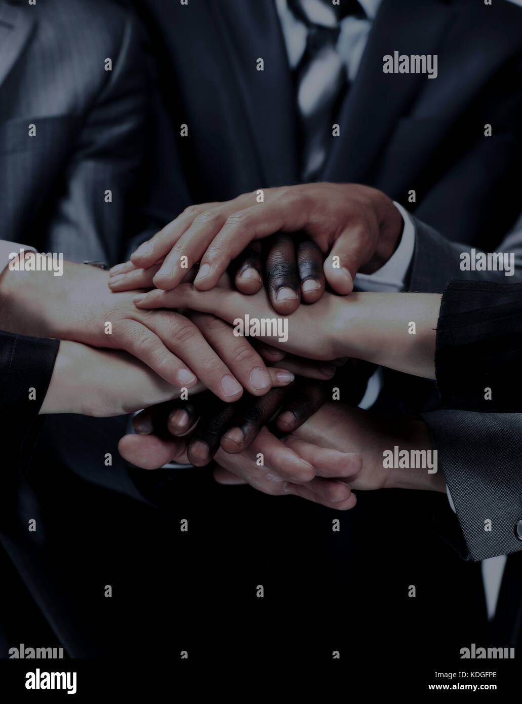 diverse group of workers with their hands together in form of teamwork Stock Photo