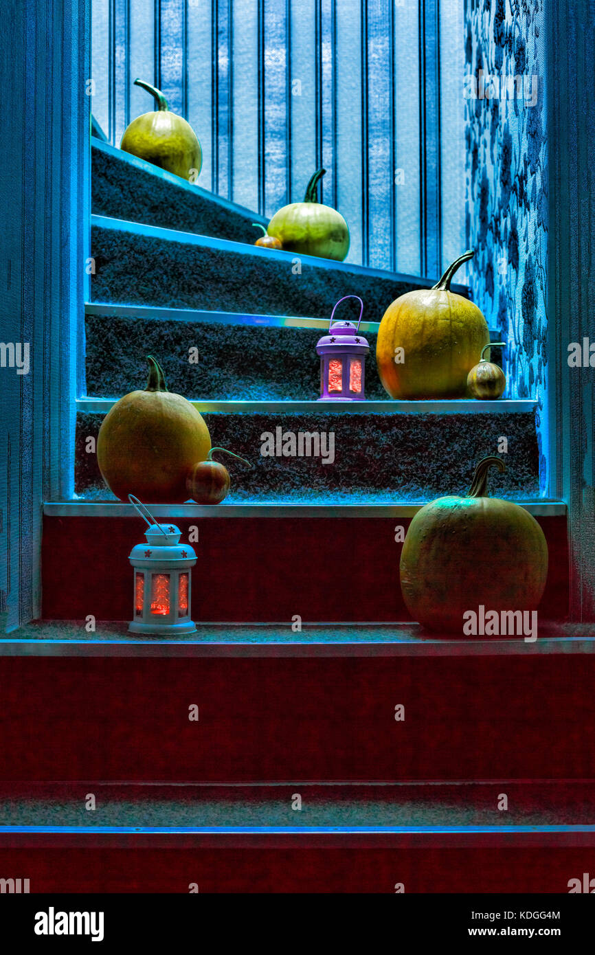 Pumpkins and lanterns on the steps in the house in mystical light ...