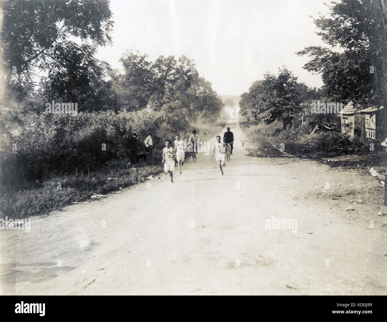 Sam Mellor, Edward Carr, and Michael Spring passing the six mile mark during the 1904 Olympic Marathon Race. (none completed the race) Stock Photo