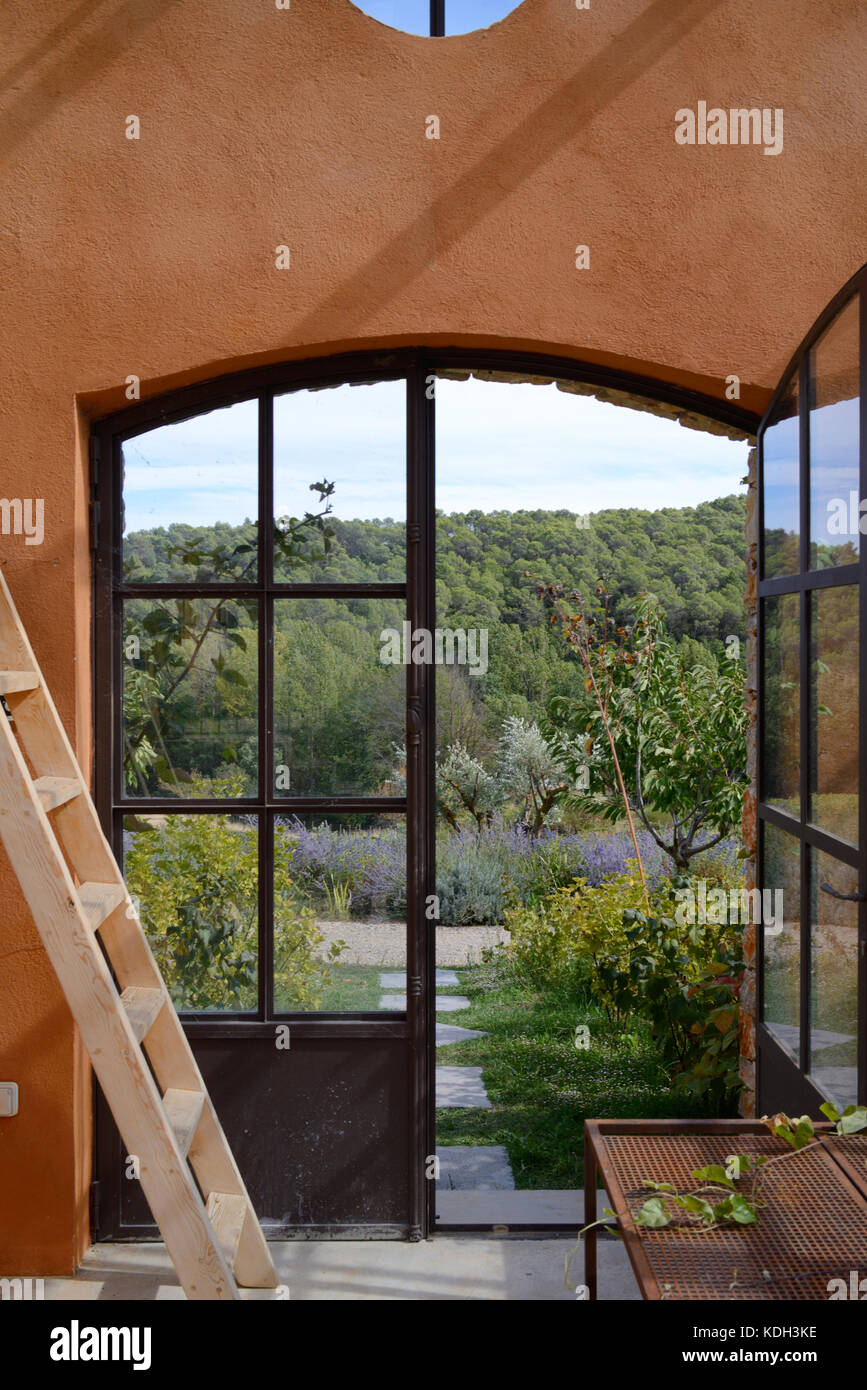 View over the Var or Provencal Forest Through Greenhouse Window in the Domaine de Berne Wine estate, Lorgues, Var, Provence, France Stock Photo