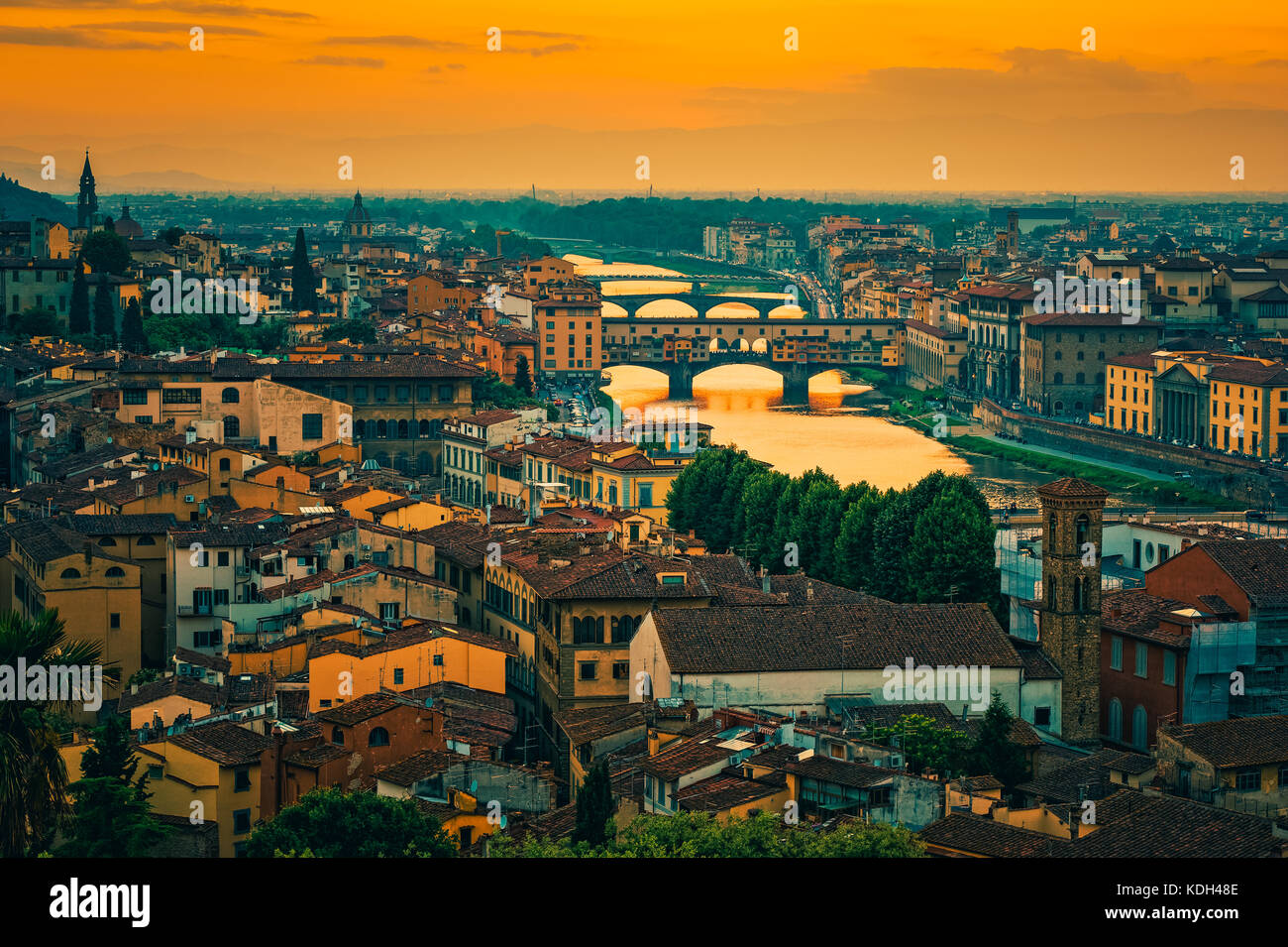 Ponte Vecchio Bridge, Arno River and Skyline of Florence, Tuscany, Italy around sunset Stock Photo