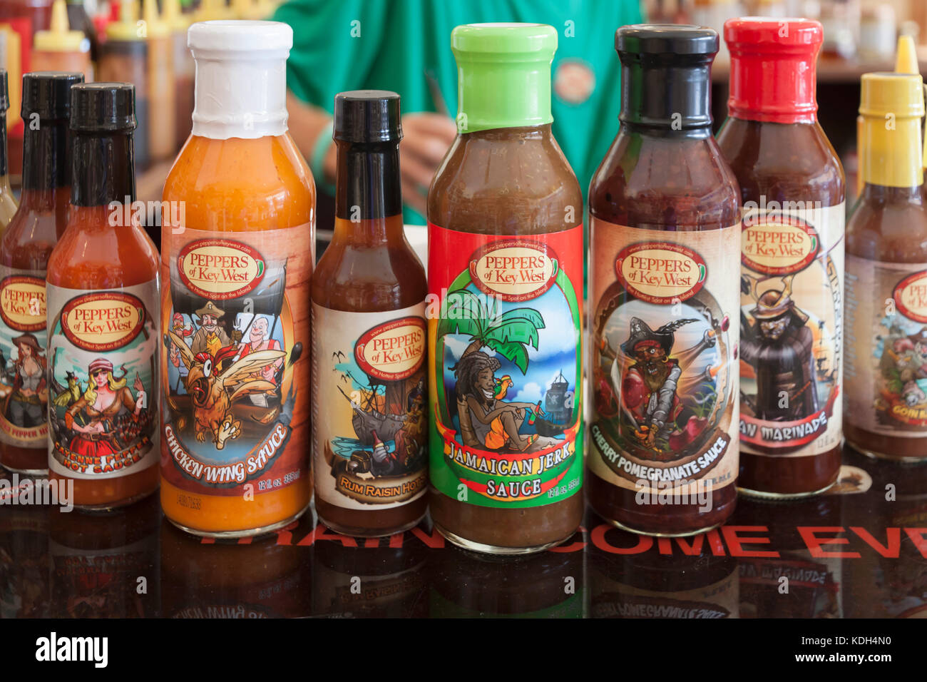 A variety of house brand bottled sauces on display in a store in Key
