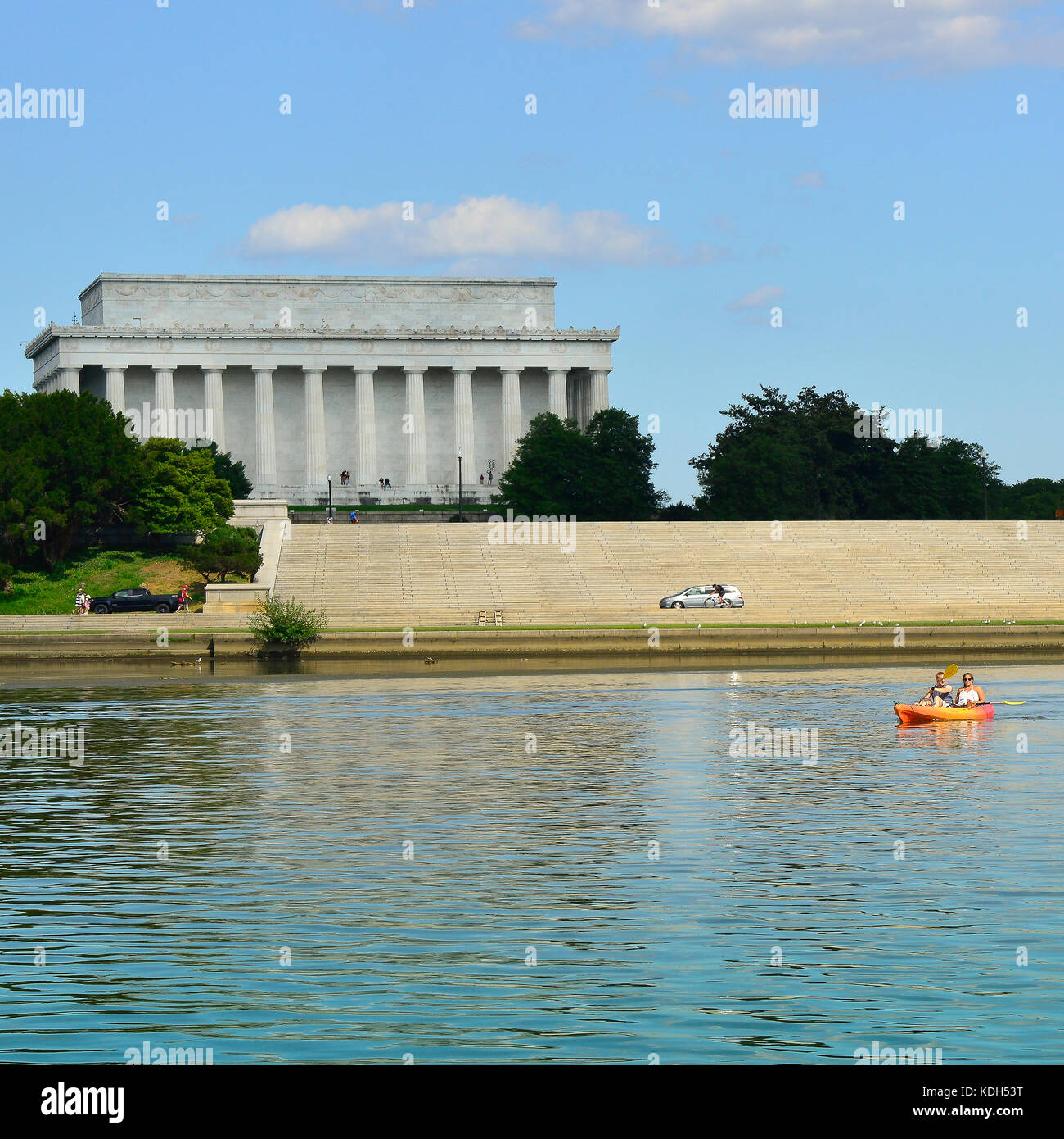 A couple Canoeing in the Potomac River paddle by the Lincoln Memorial