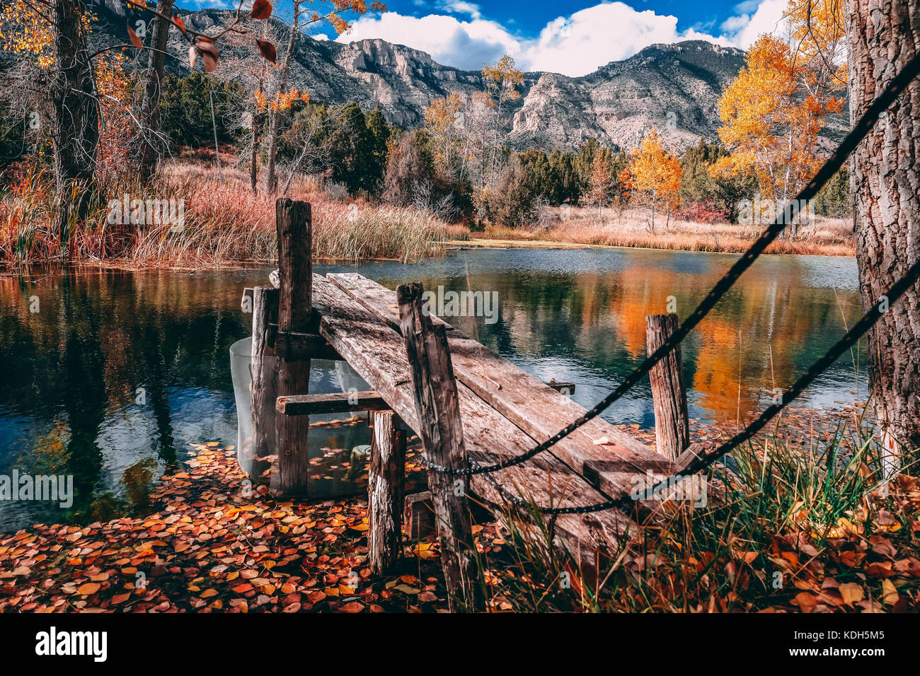 Small Dock on Mountain Pond in Fall Stock Photo - Alamy