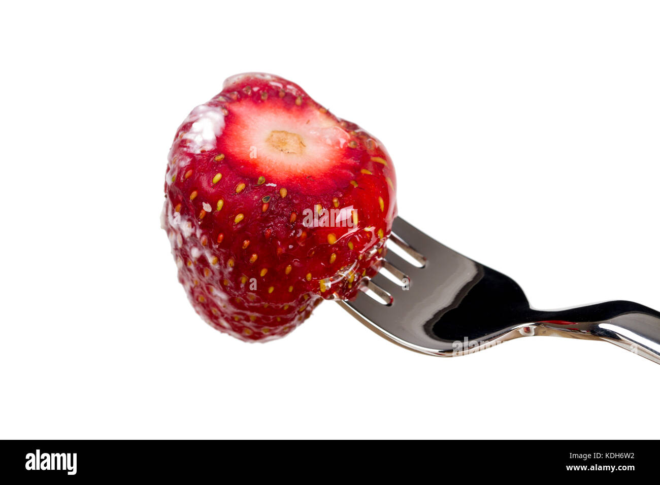 Close up detailed view of yummy strawberry on fork, isolated on white