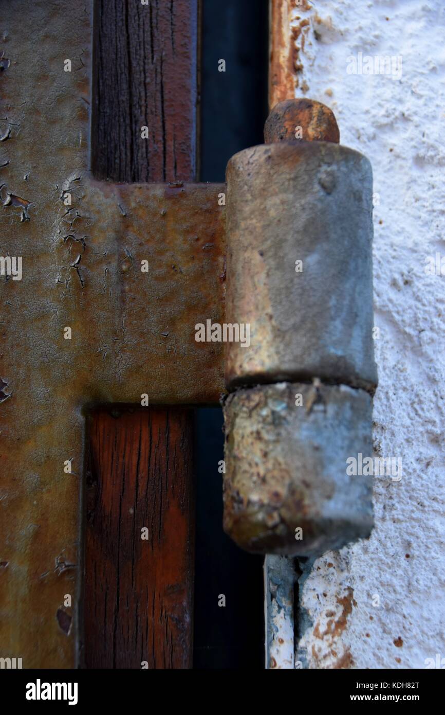 old and rusty door hinge, closeup of rusty door hinge with peeled